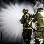 Fire,Team,Training,With,Wide,Pattern,Hose,On,Burnt,Car