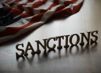 Global Economy Watch: U.S. Begins Enforcing Its Iran Sanctions Against a Third-Country Bank