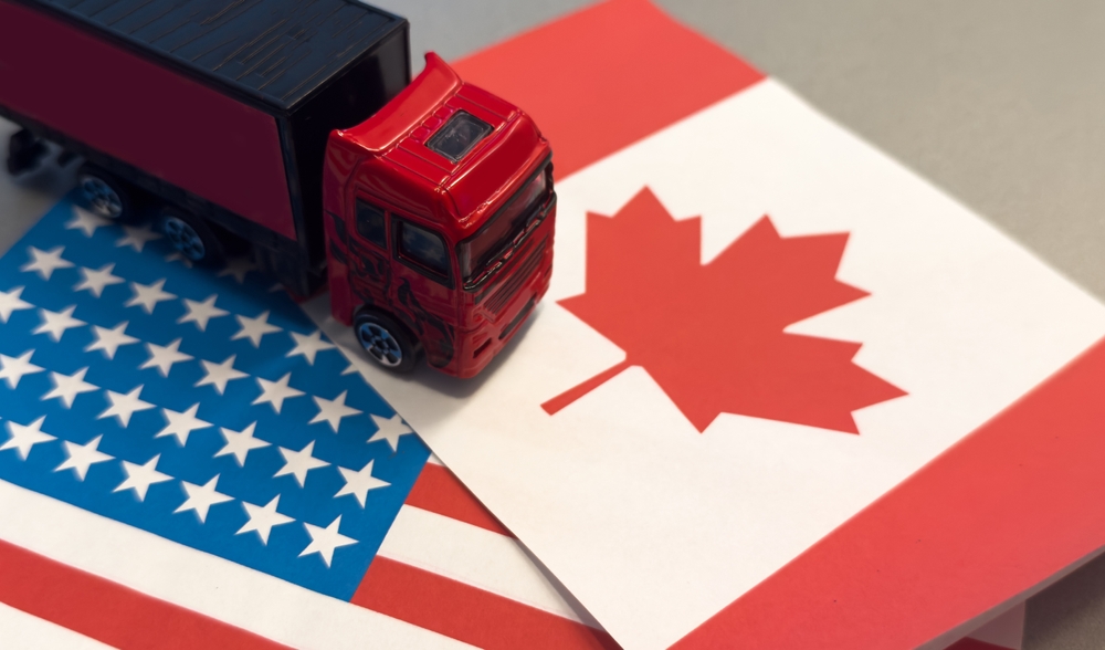 Us,Canada,Flag,In,The,Background.,Truck,,Transport,,Freight,Transport.