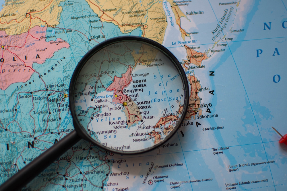 A,Magnifying,Glass,Focuses,North,Korea,And,South,Korea,On