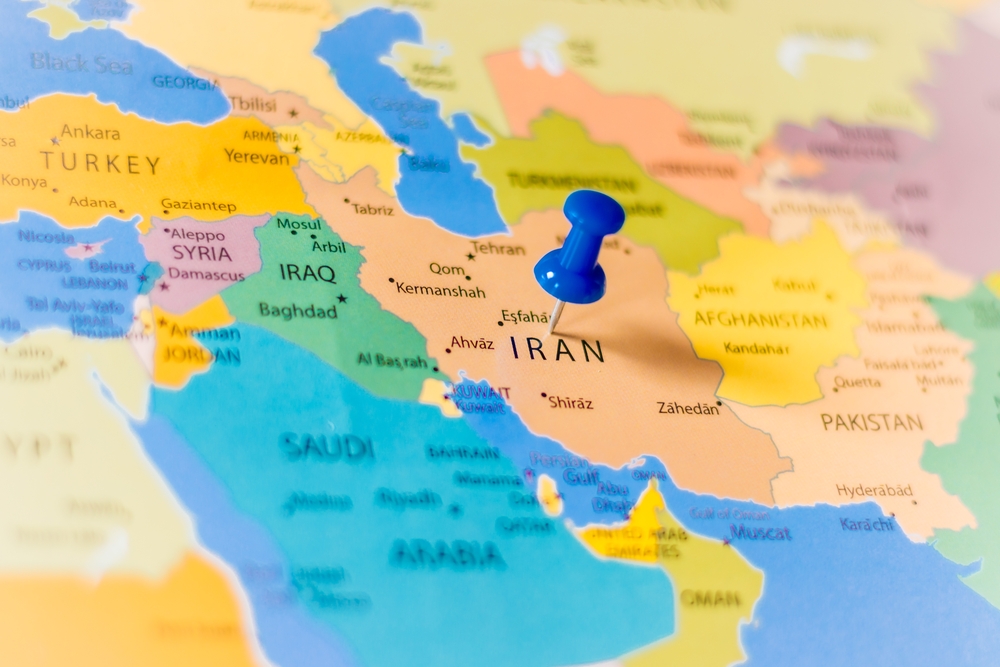 Blue,Push,Pin,Pointing,At,Iran,On,A,Political,World
